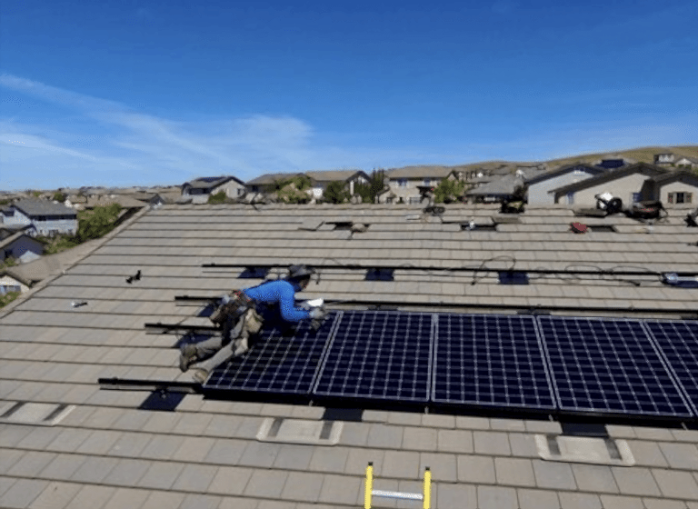 Solar Bill Review installer working on rooftop solar panel installation — local skilled professionals